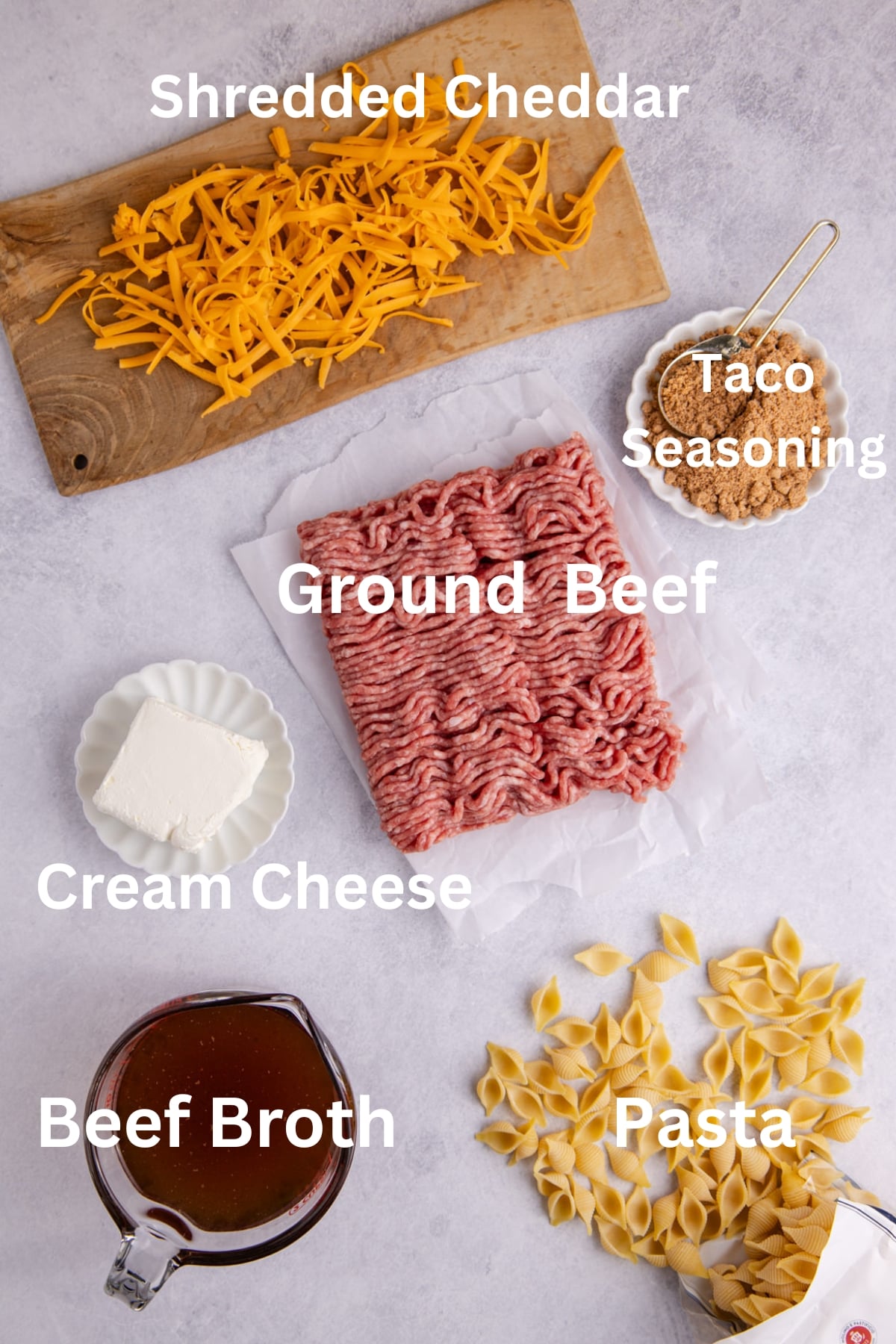 Ingredients to make this hamburger helper on a table.