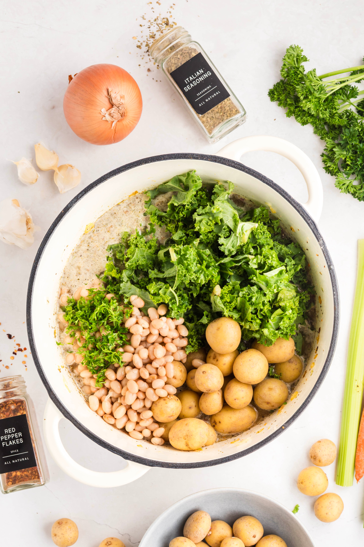 Kale, beans and potatoes added to the pot.