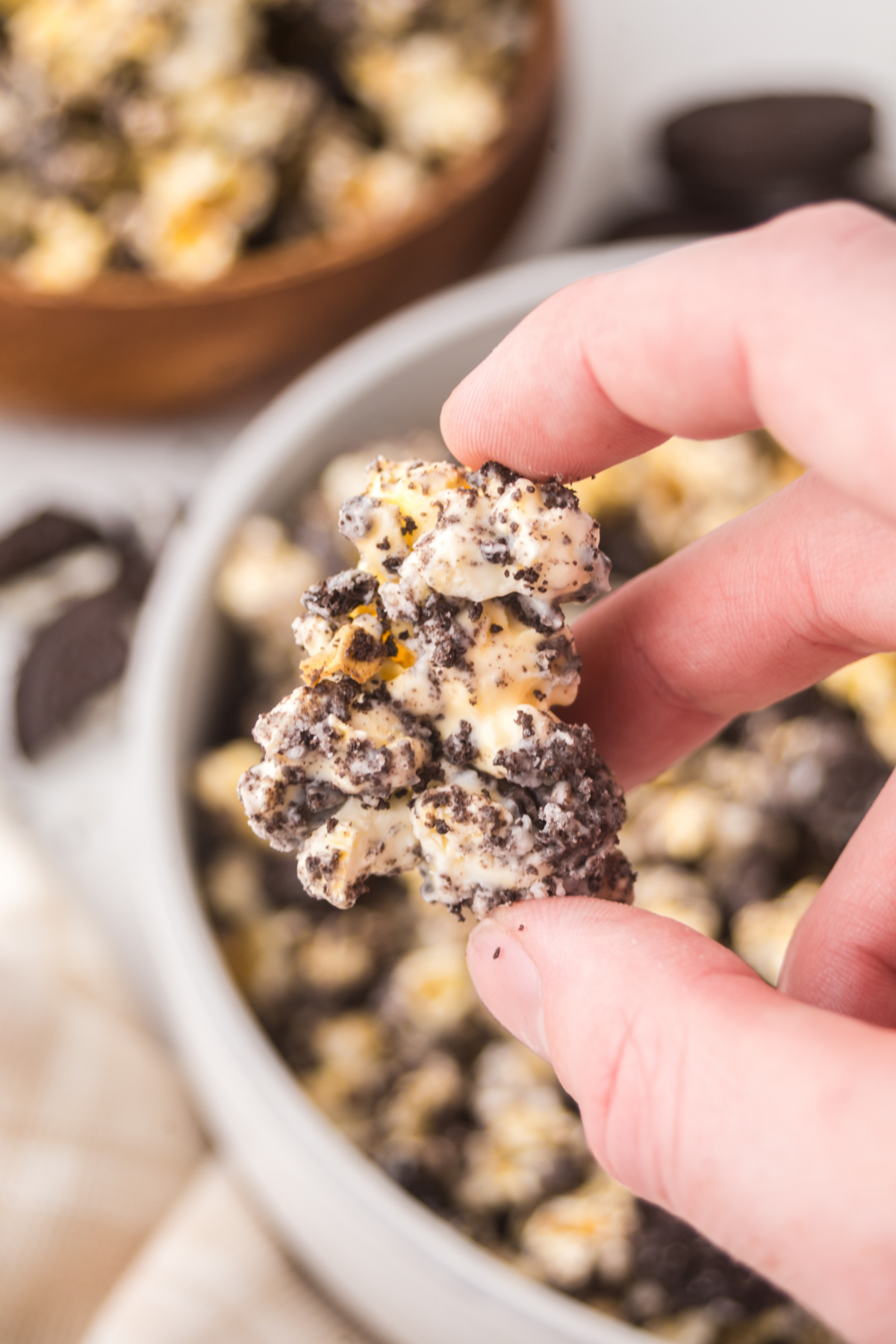 A piece of popcorn held in the air.