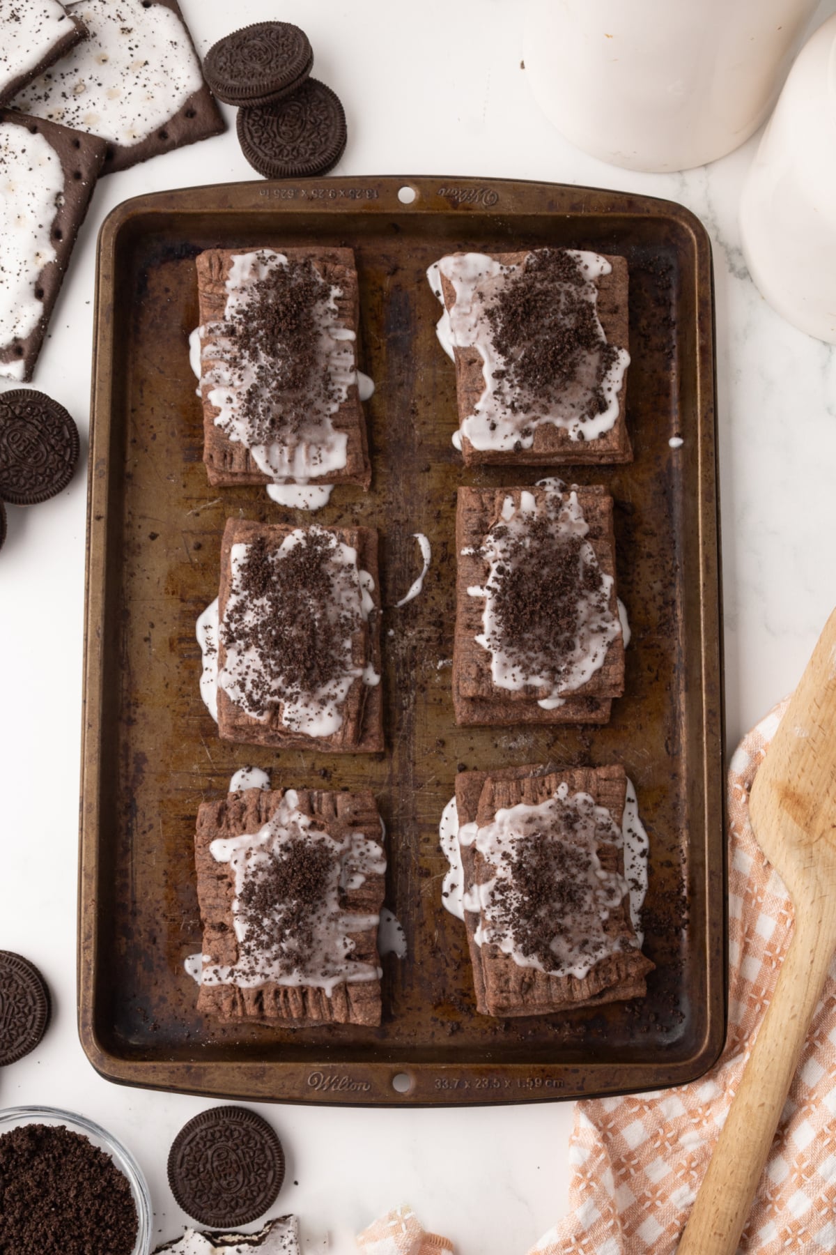 Six made pop-tarts on a baking sheet ready to eat.