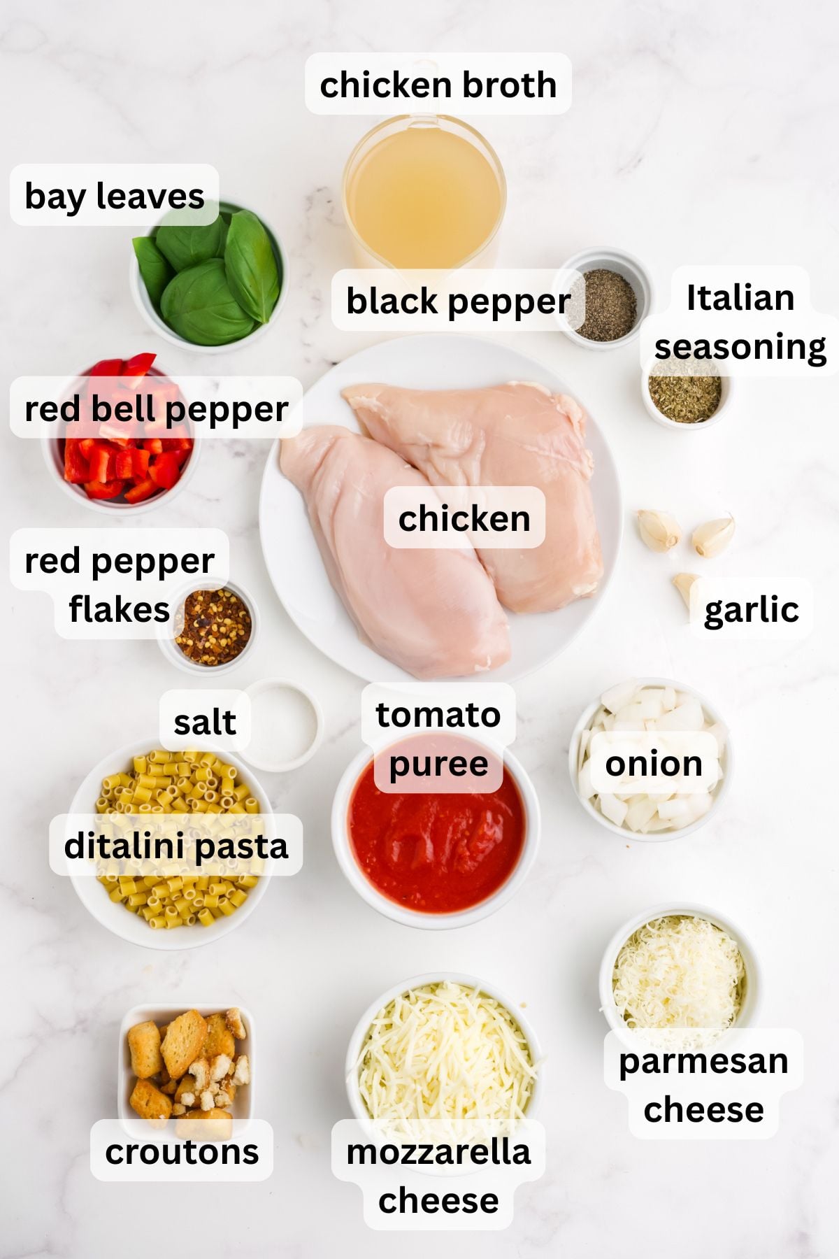 Ingredients to make this soup in bowls on a table.