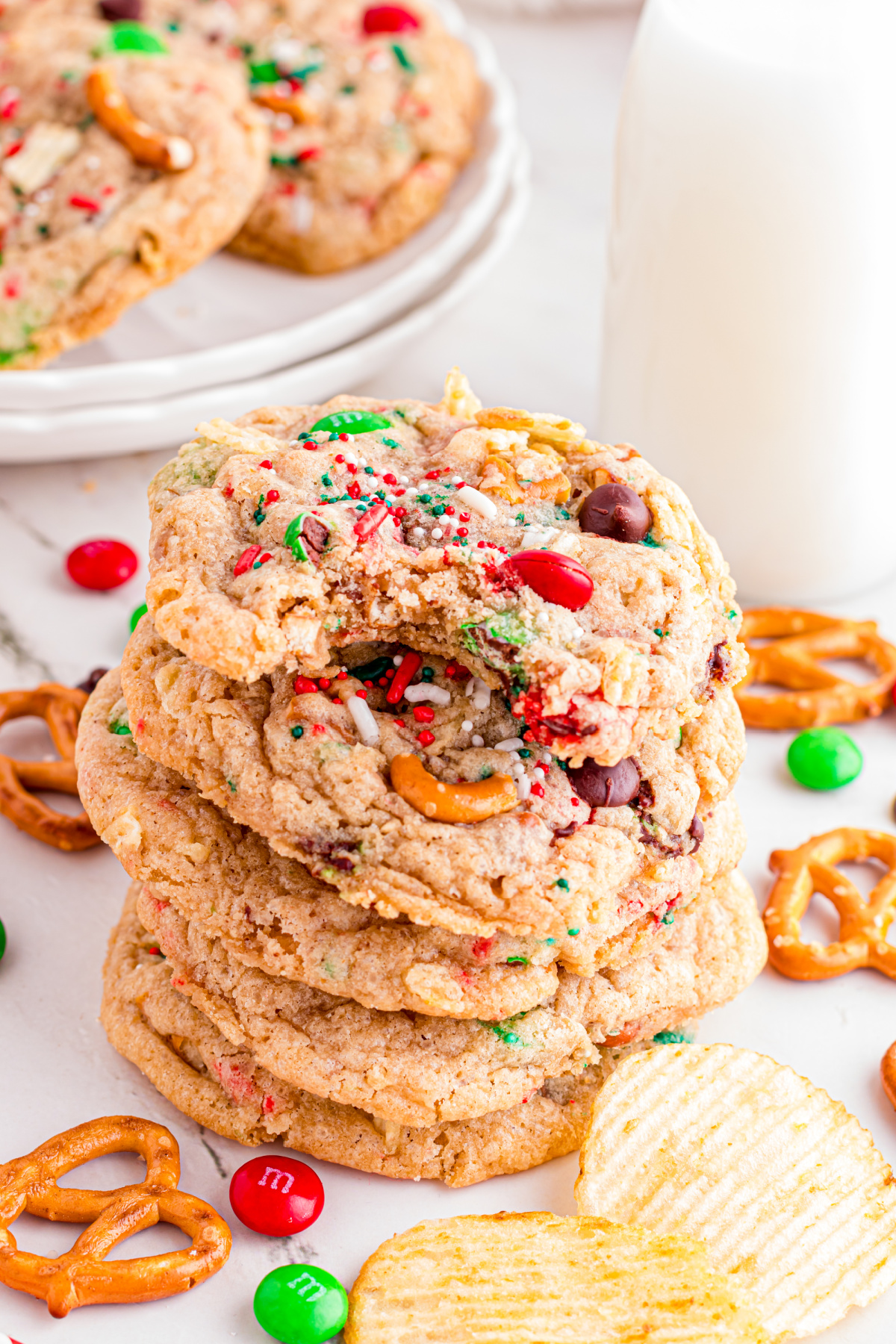 Cookies with m&m, pretzels and other candies stack on top of each other. 