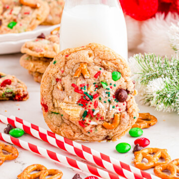 Santa trash cookies leaning up against a milk jar.