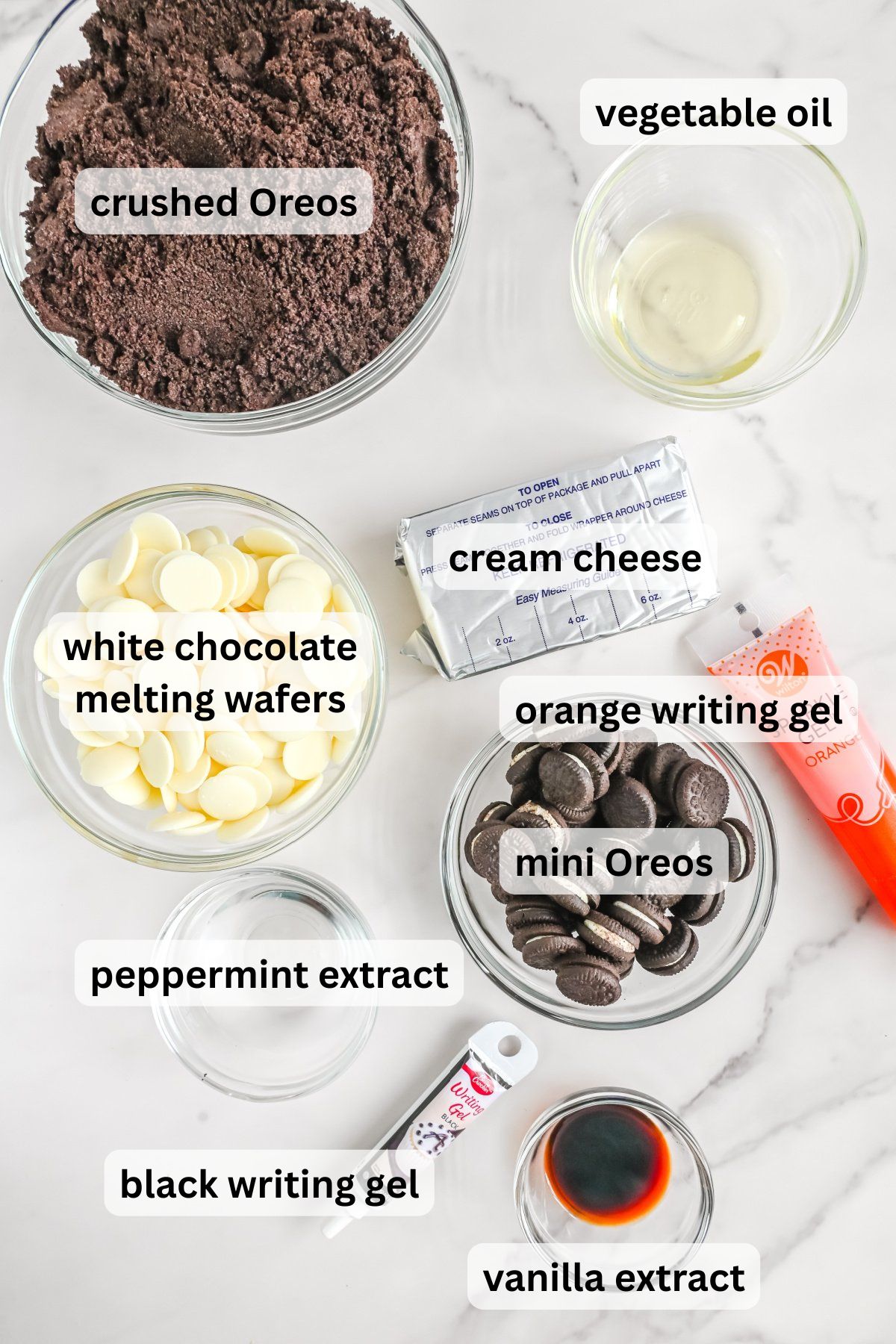 Ingredients to make these Oreo balls in bowls on a table.