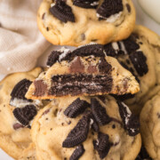 A pile of Oreo stuffed cookies with the top one cut in half.