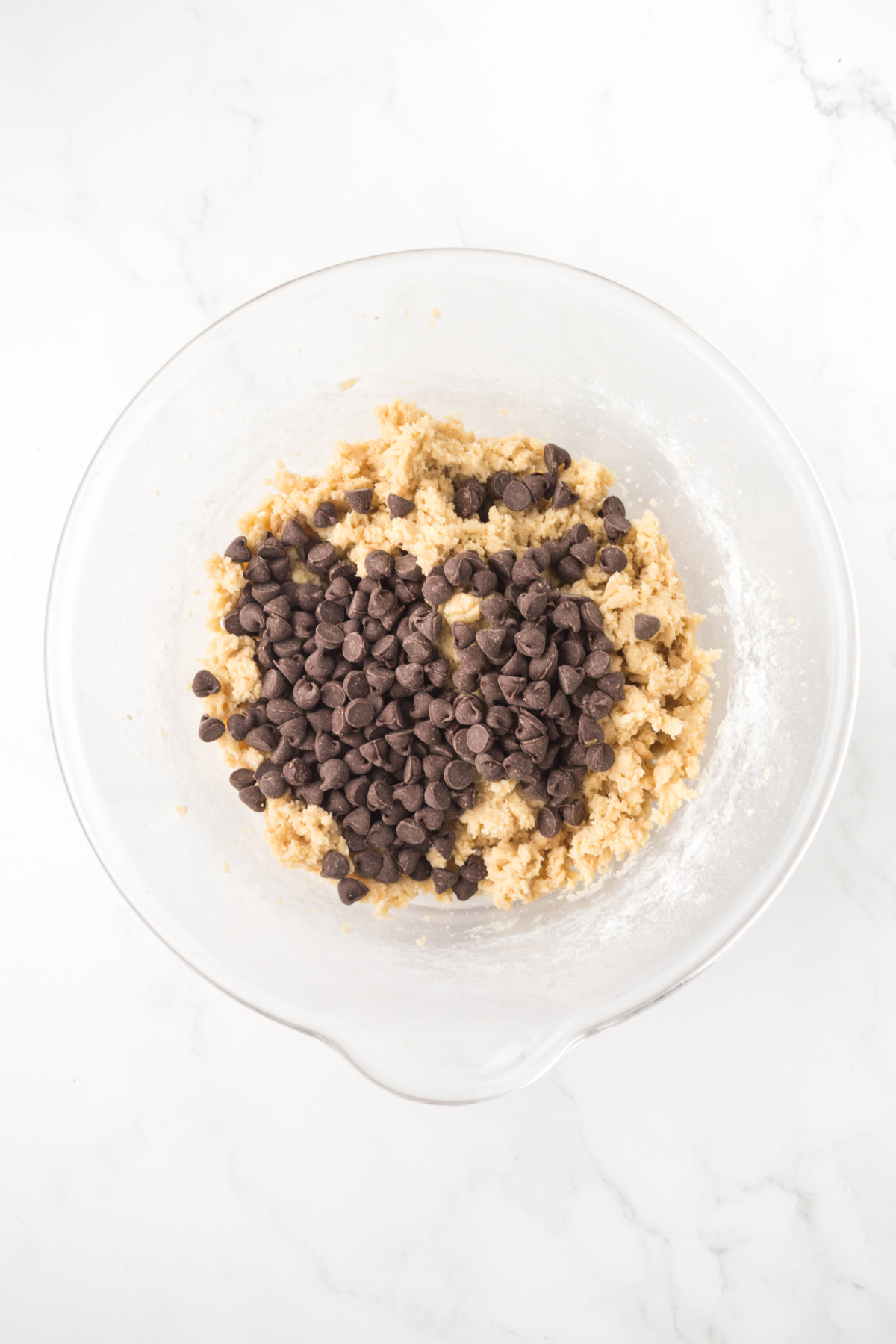 All of the dry ingredients are added including chocolate chips to create the dough.