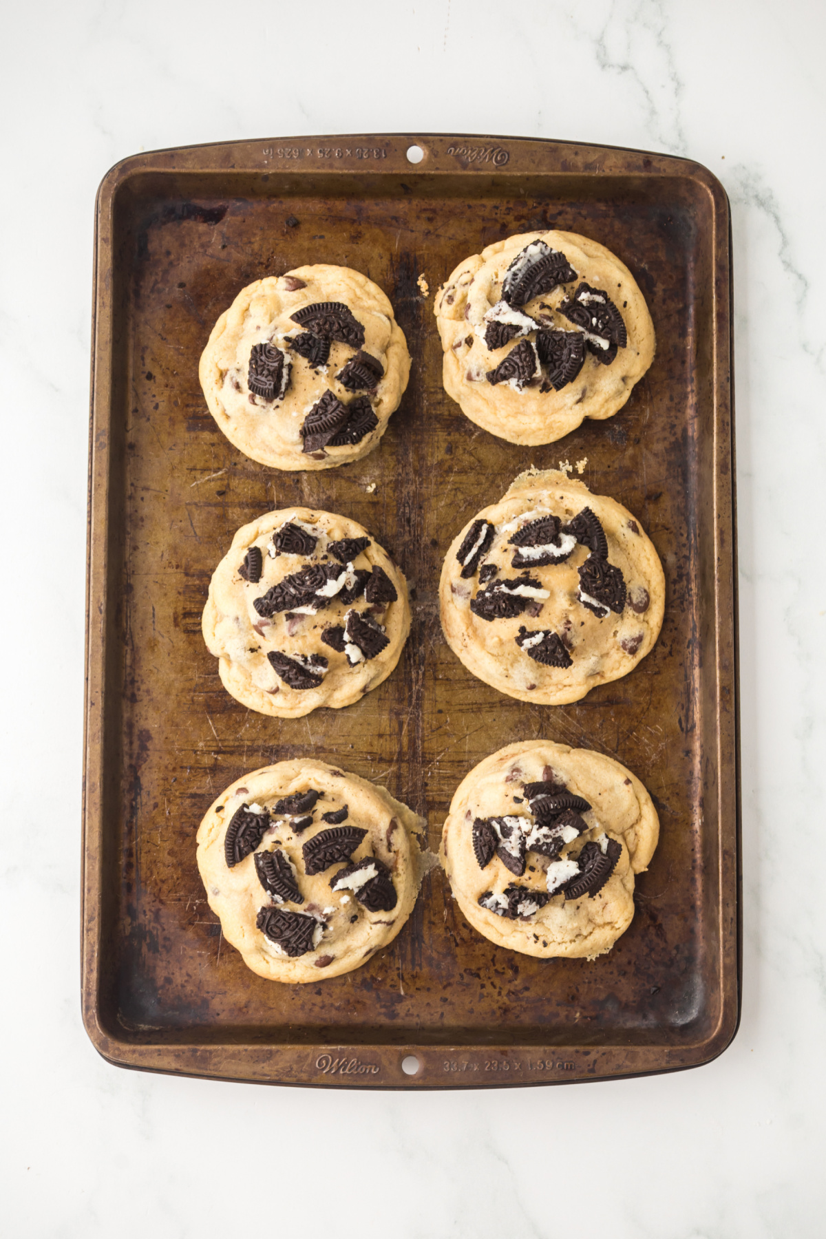 Baked cookies cooling on the baking sheet.