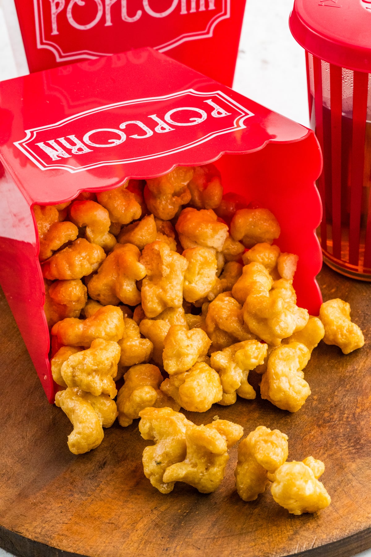 A bucket filled with beaver nuggets tipped over on a table.