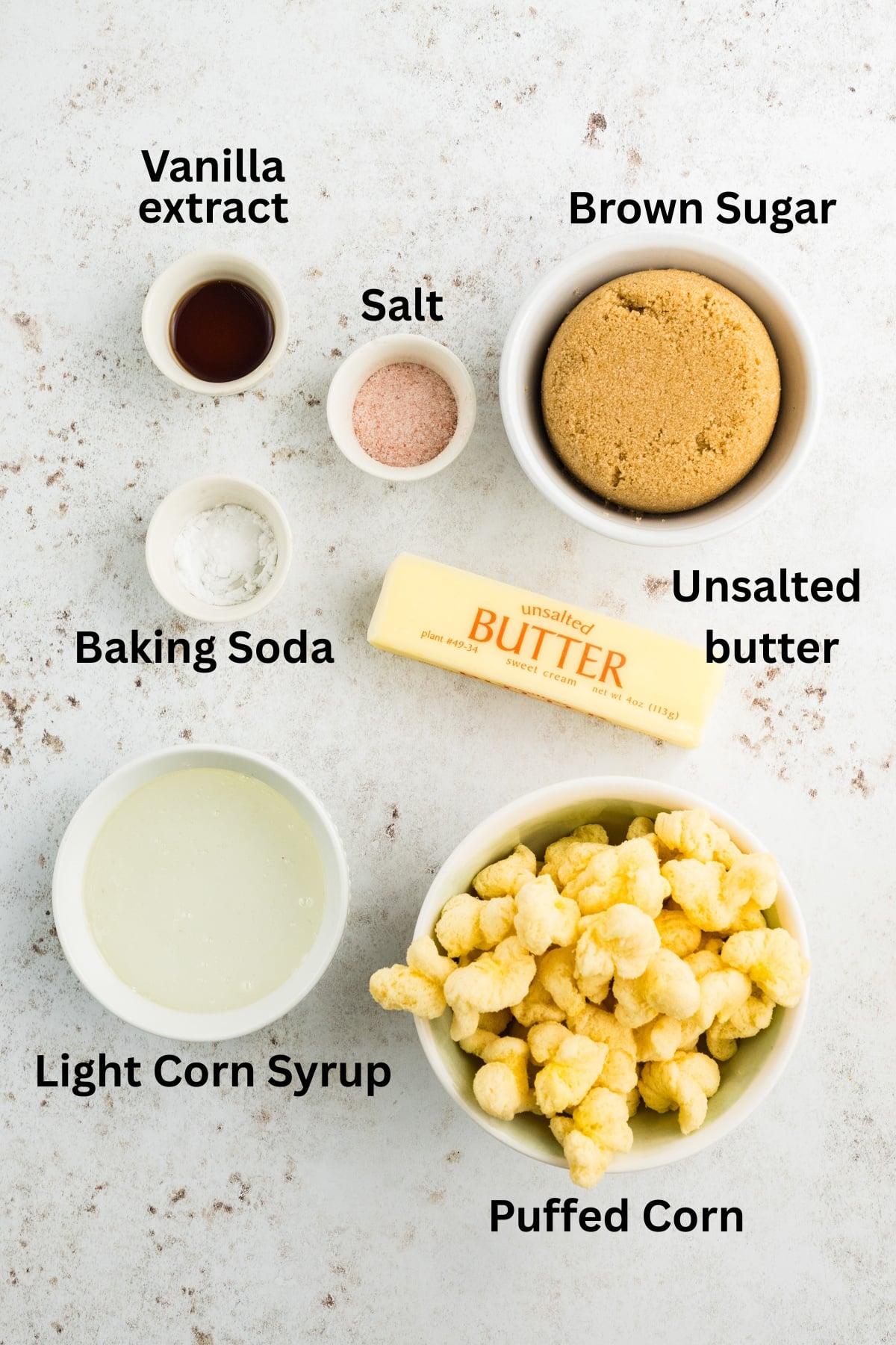 Ingredients to make this puffed corn in bowls on a table.