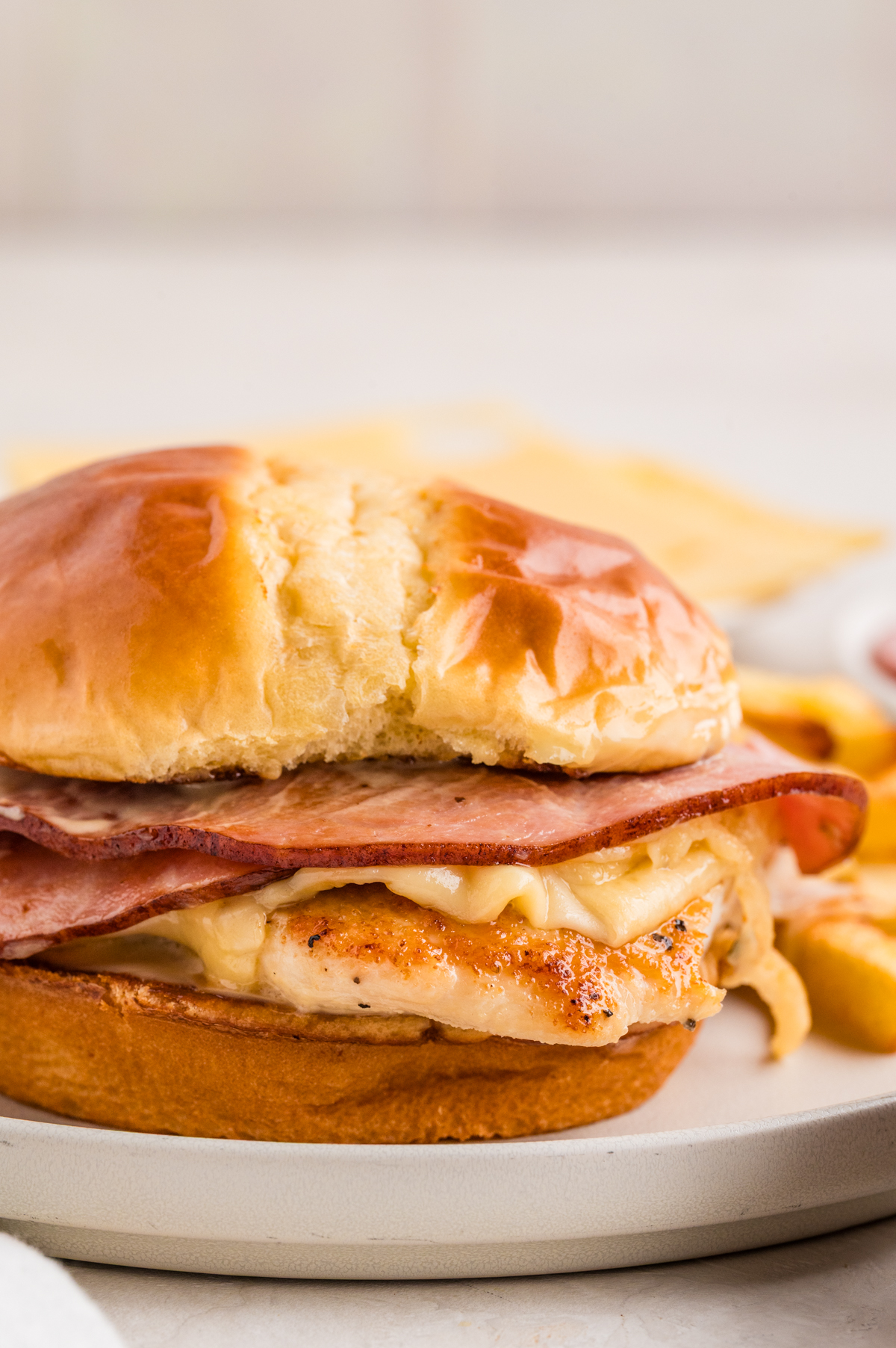 Chicken, ham and cheese assembled on a plate for serving.