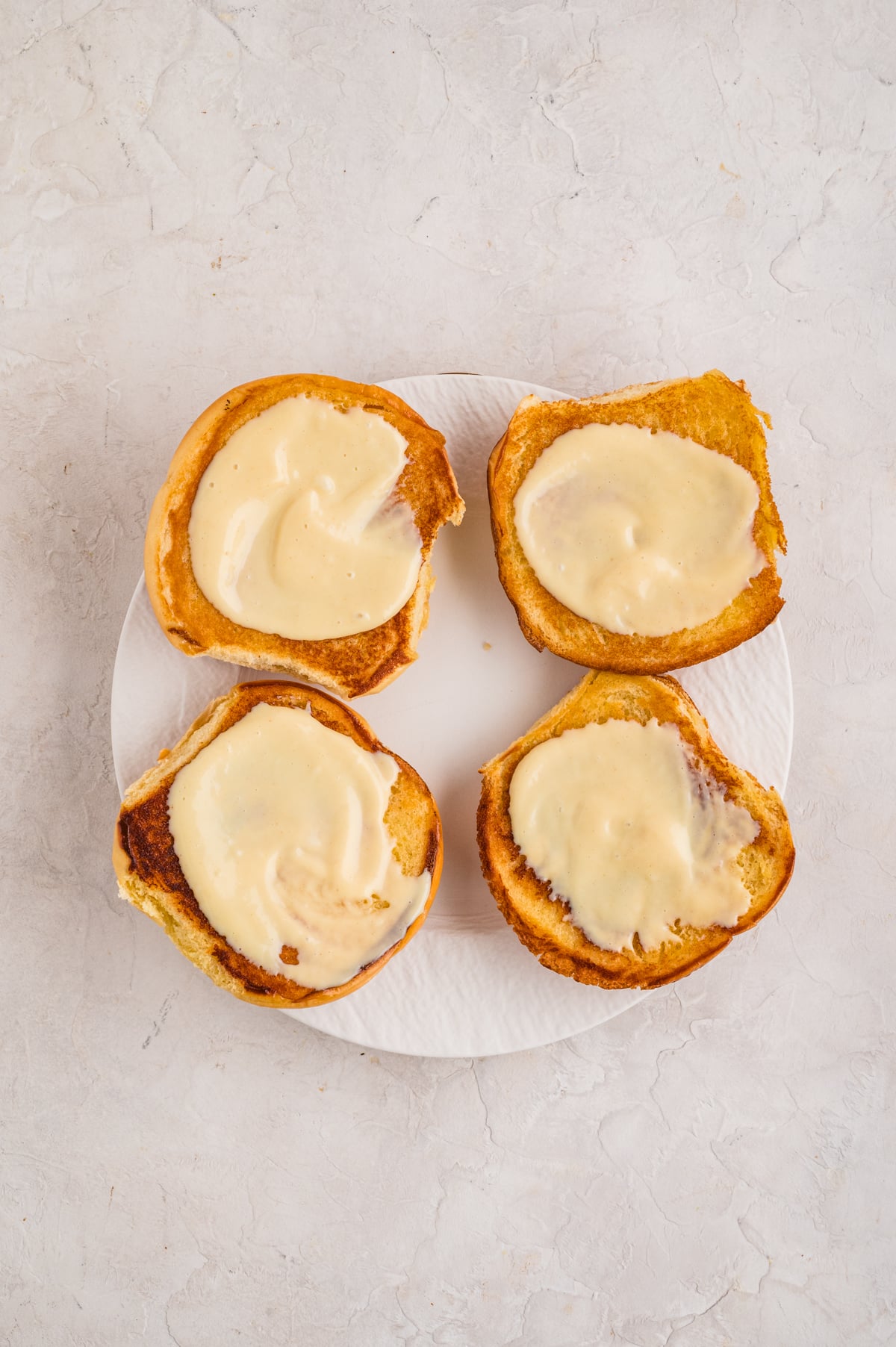 Honey Dijon sauce spread on each side of the toasted buns.