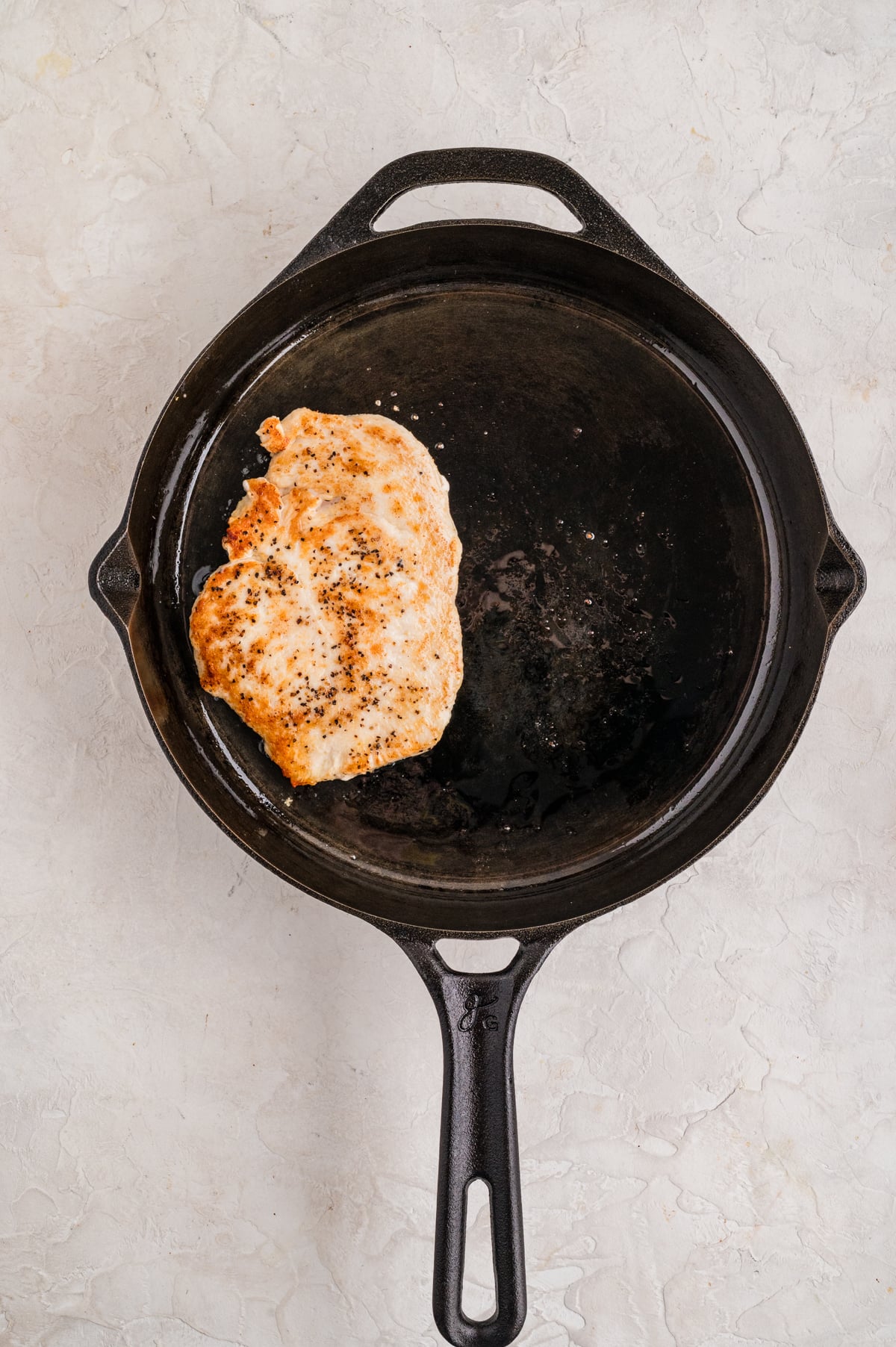 Chicken cooking on a skillet.