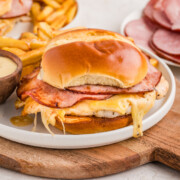 A chicken cordon bleu sandwich on a white plate.