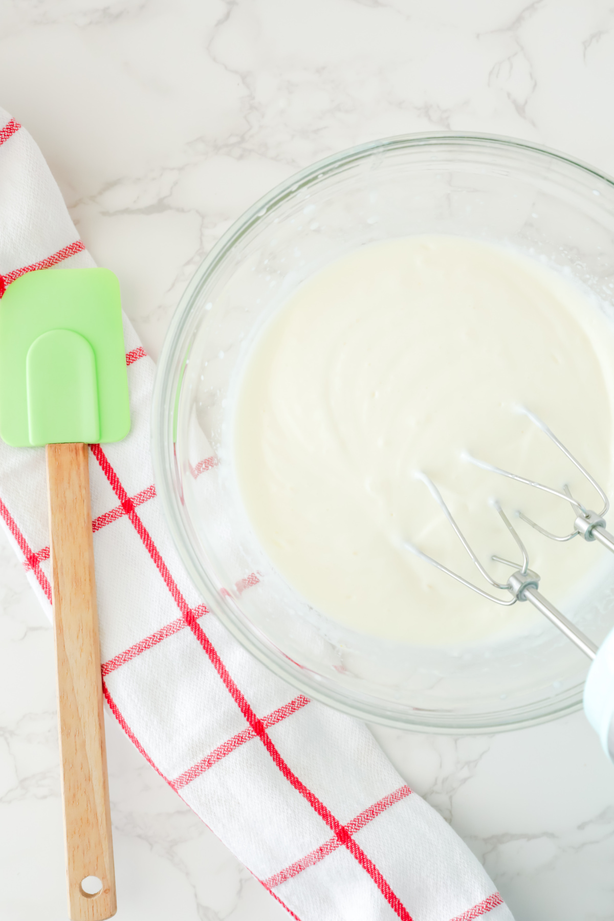 Milk and pudding mix combined in a bowl.