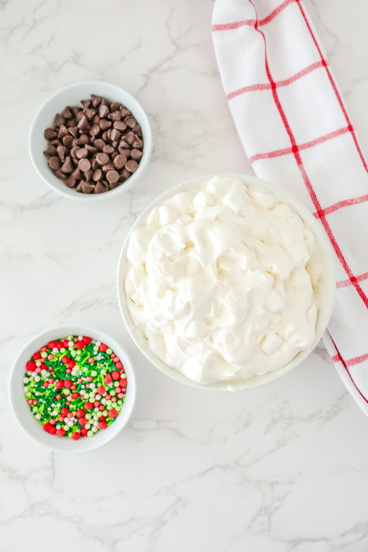 Whipped topping and mini marshmallows added to the bowl.