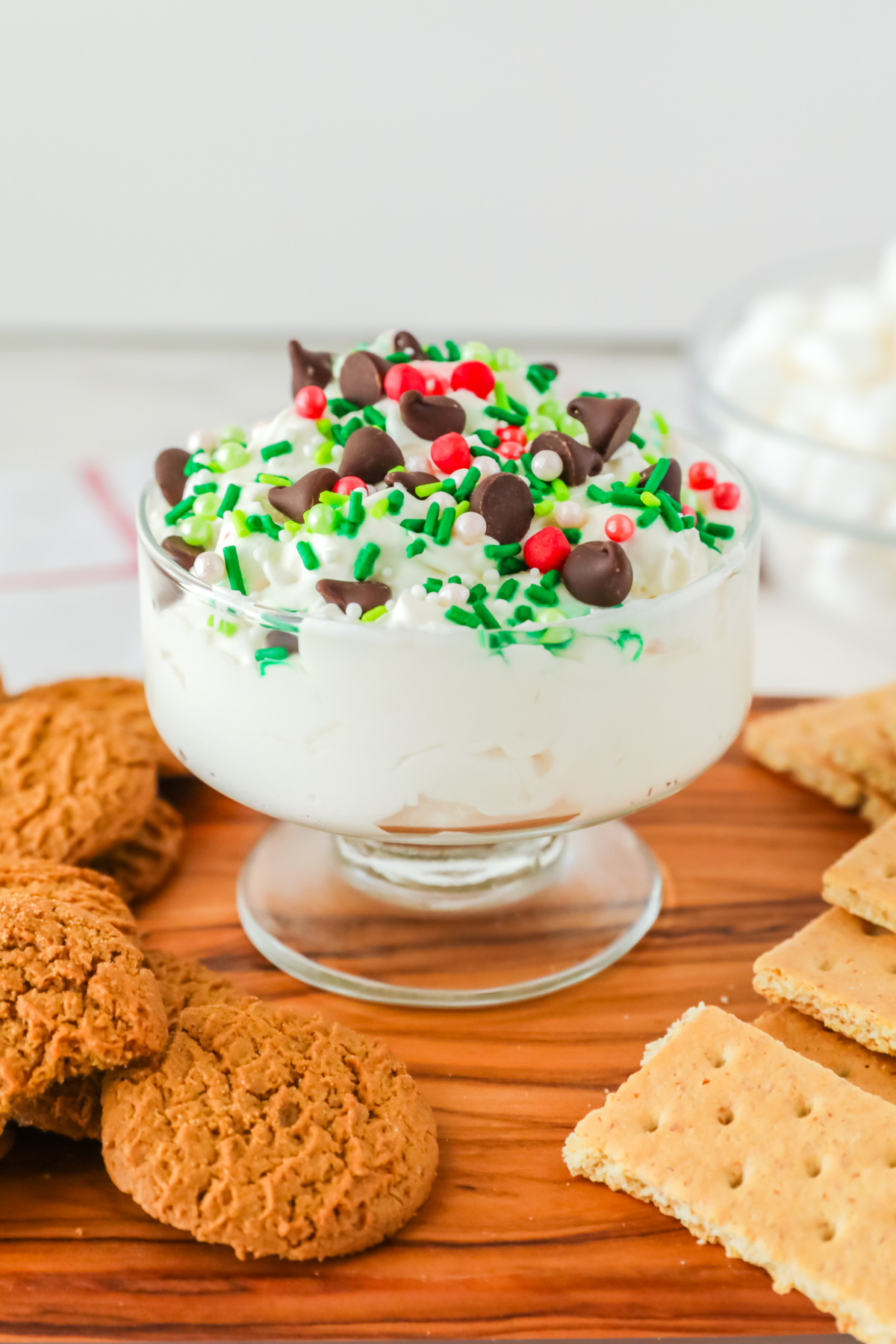 A dish with fluff in it with Christmas sprinkles and chocolate chips.
