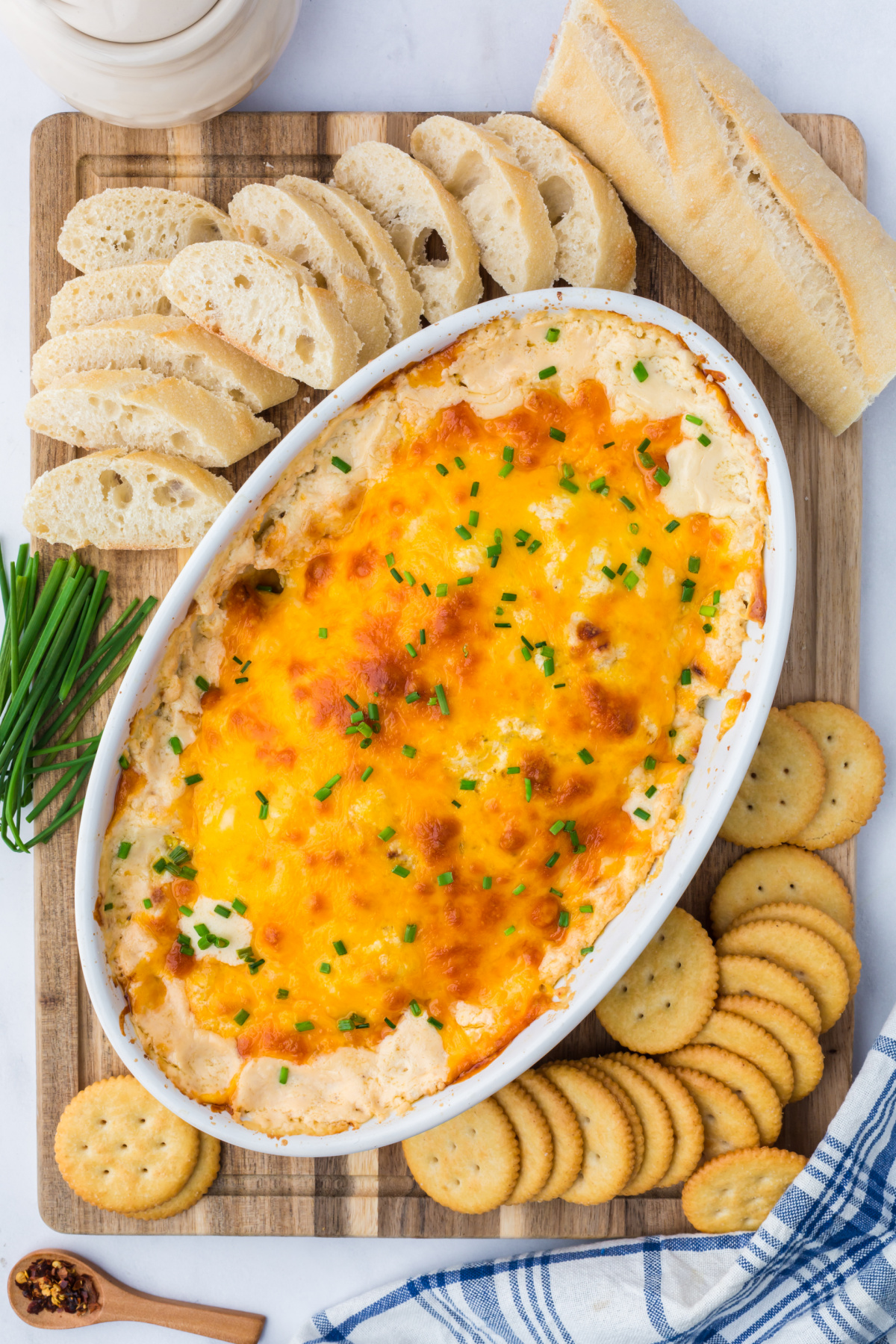 Crab dip surrounded by crackers and bread.