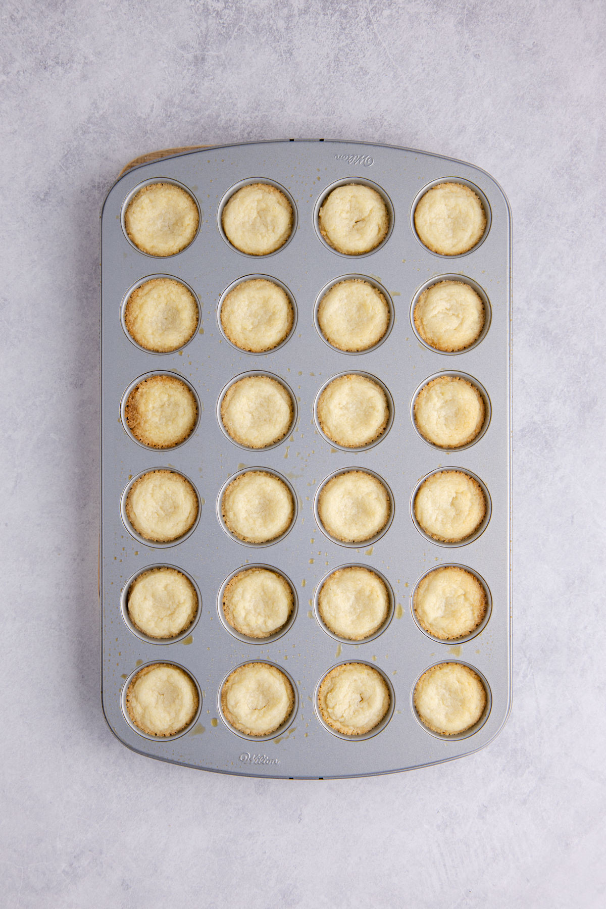 A scoop of cookie dough into each cavity to bake in a mini muffin tin.