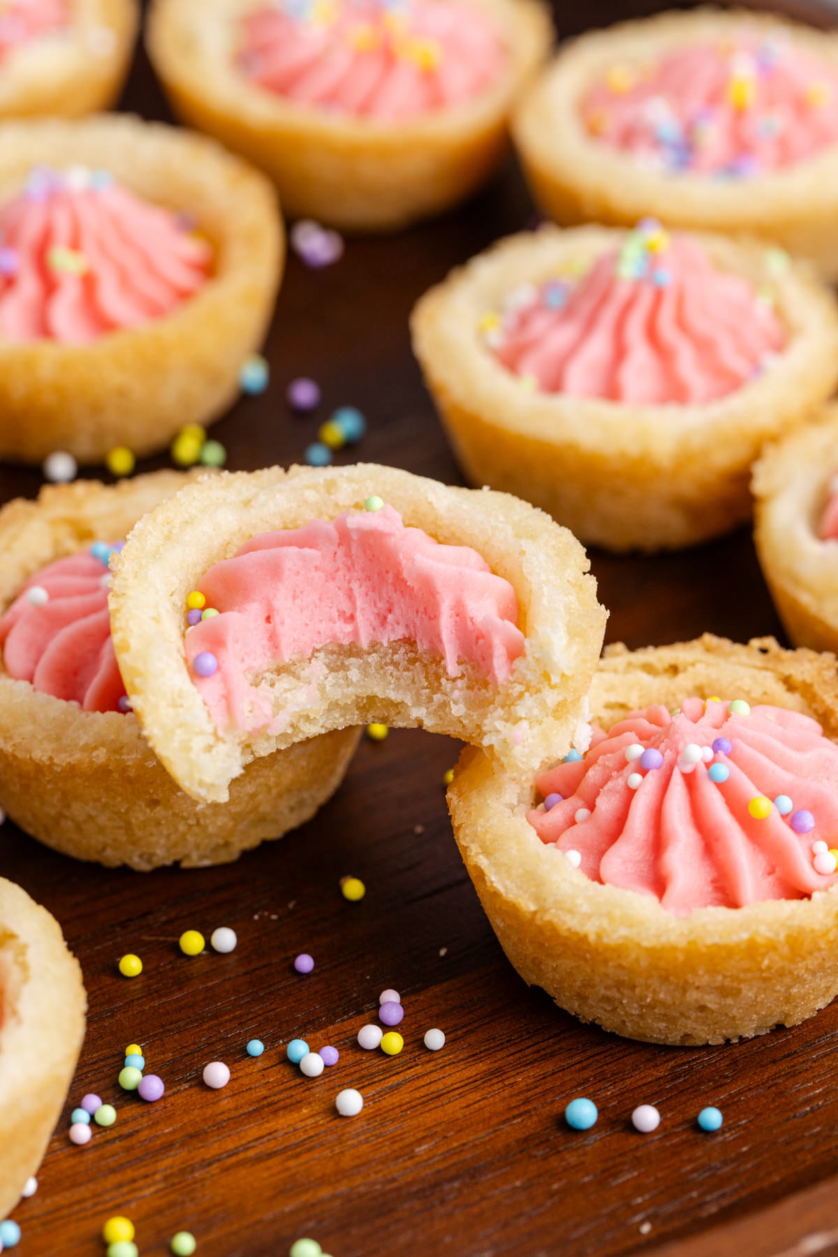 A Easter cookie cup on top of other cookie cups with a bite taken out of it.