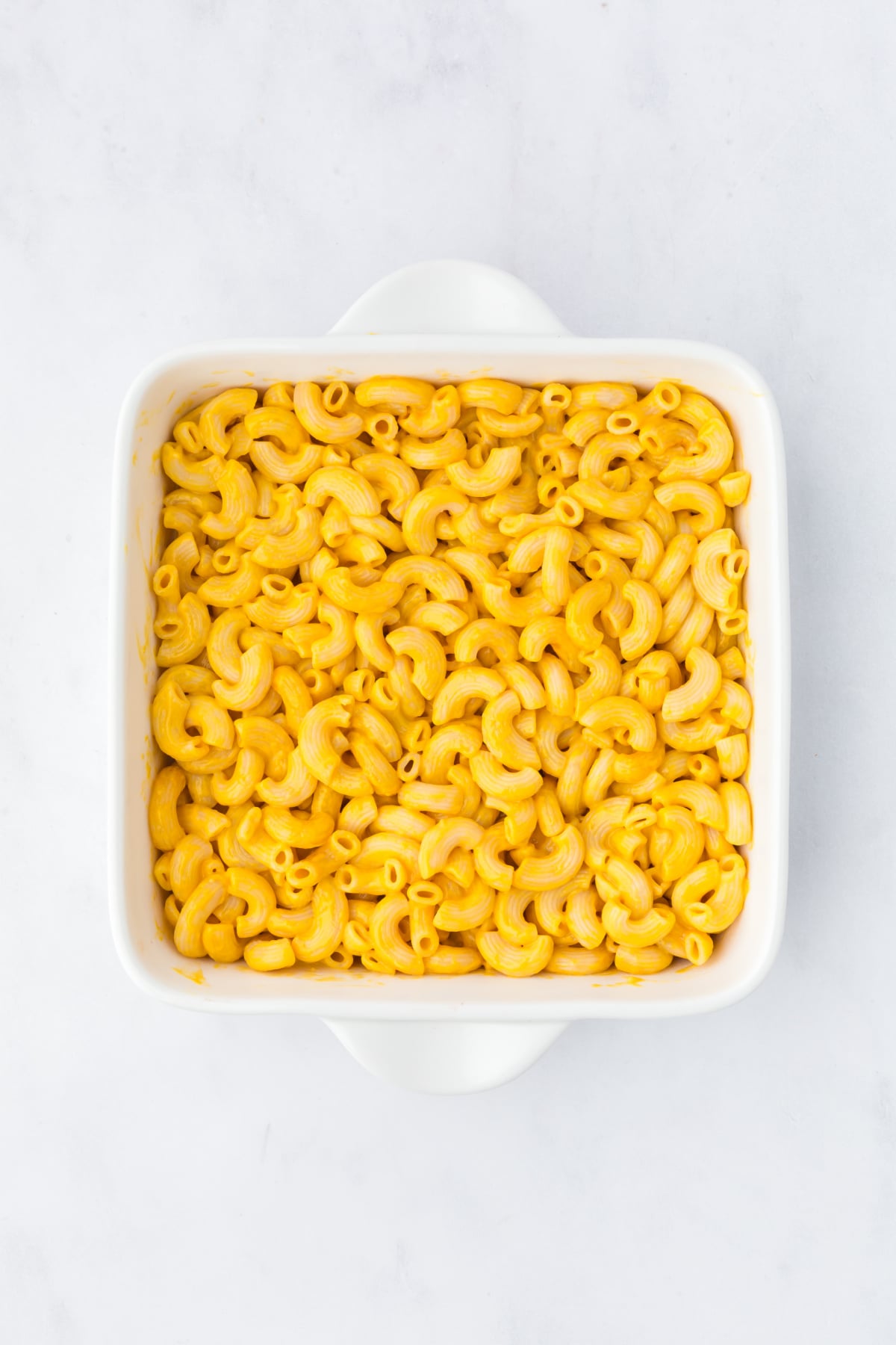 Mac and cheese on the bottom of a baking dish.