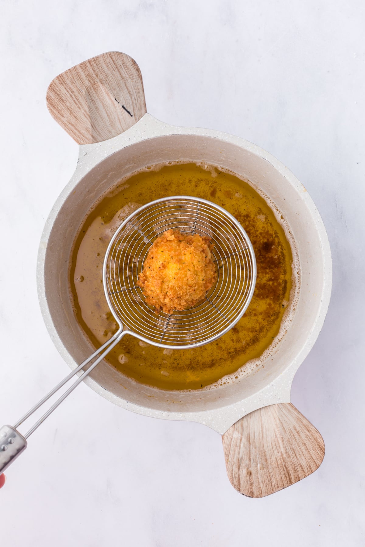 Mac and cheese balls cooked in hot oil.