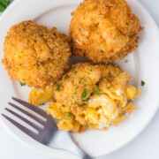 Fried mac and cheese balls on a plate.