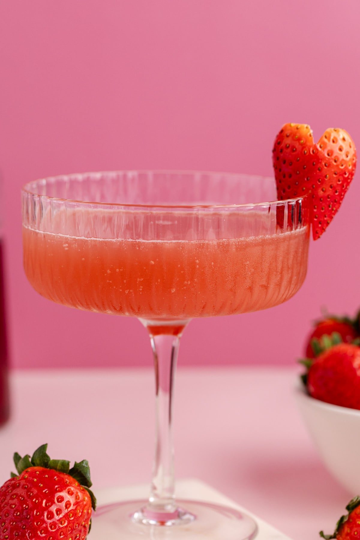 A cocktail glass filled with grenadine, vodka and juice.