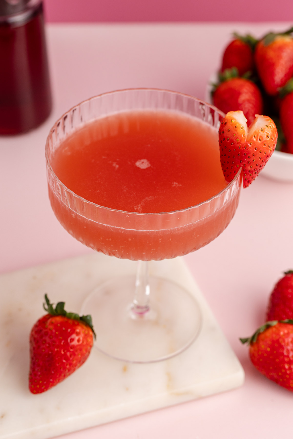 A strawberry cocktail in a glass.