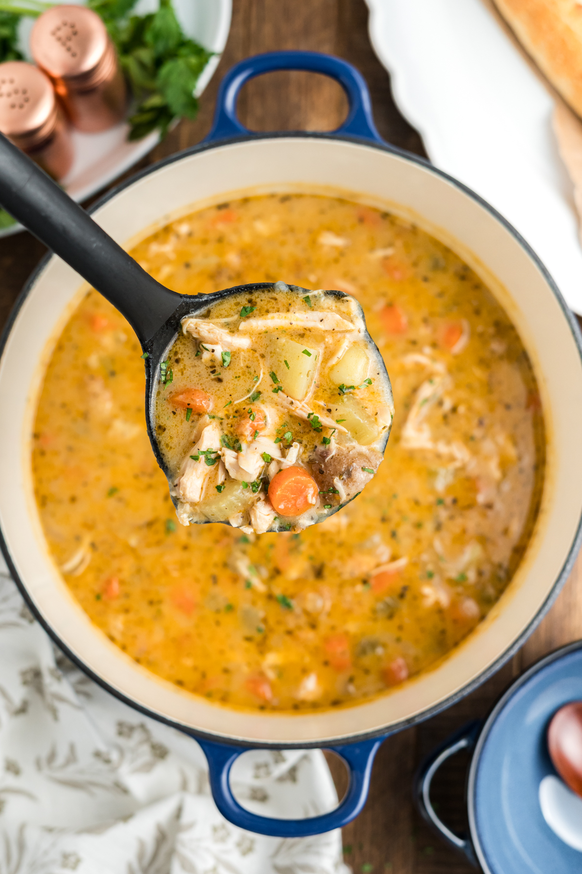 The stew finished and a ladle scooping some out.