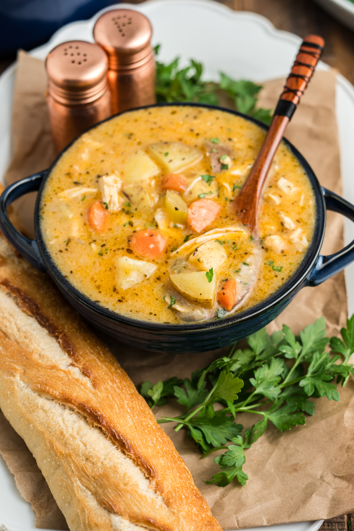 A stew with chicken, potatoes and carrots in a bowl.