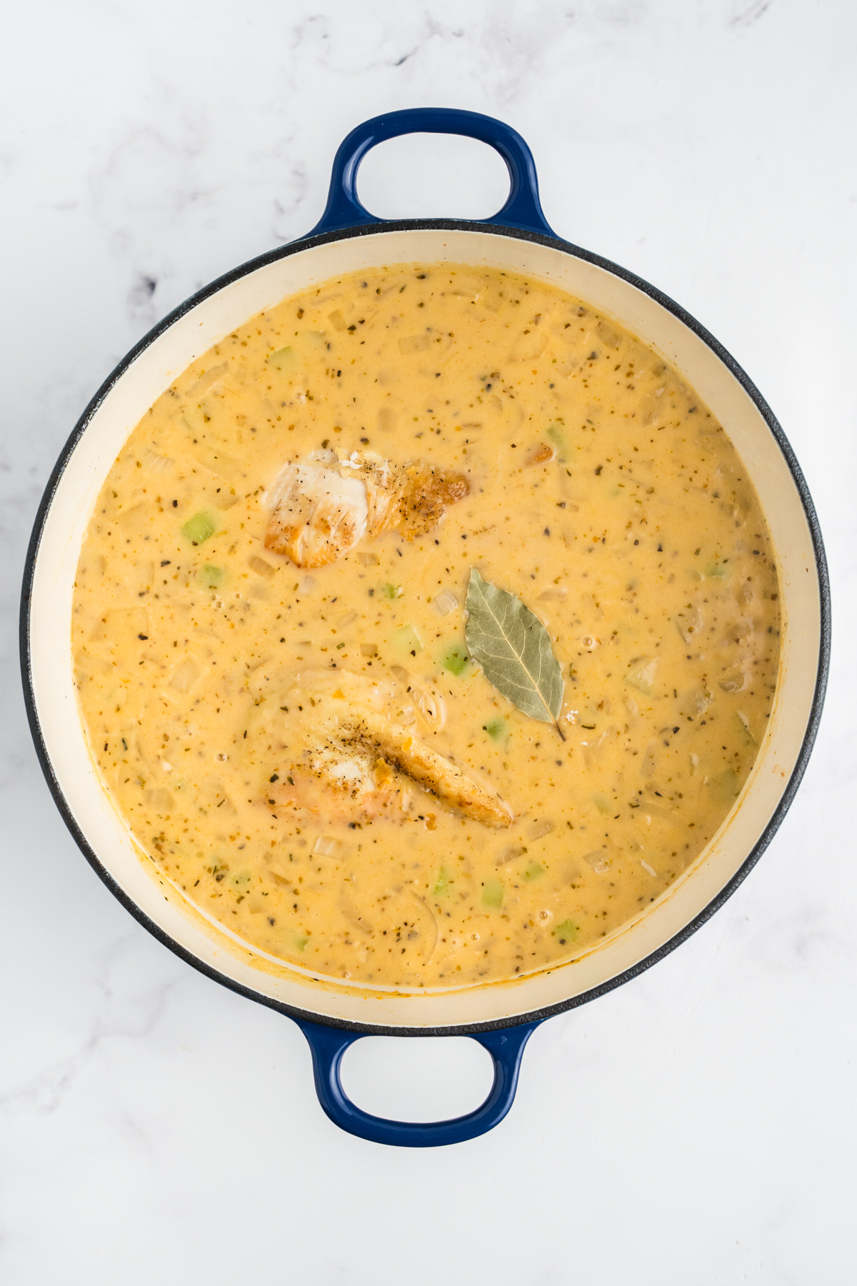 Chicken and bay leaf added to the stew.