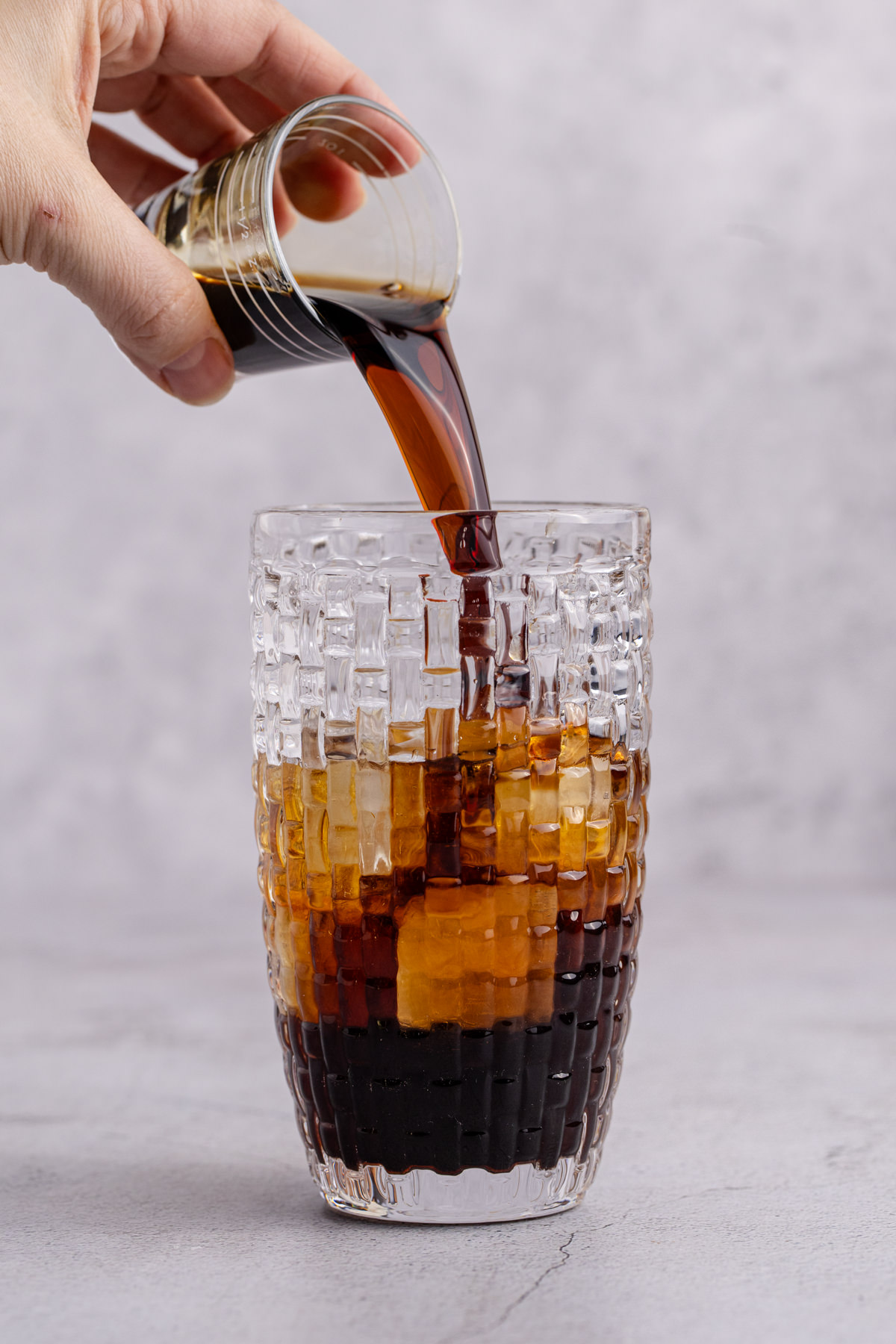Peanut Butter Whiskey being added to cocktail shaker with ice.