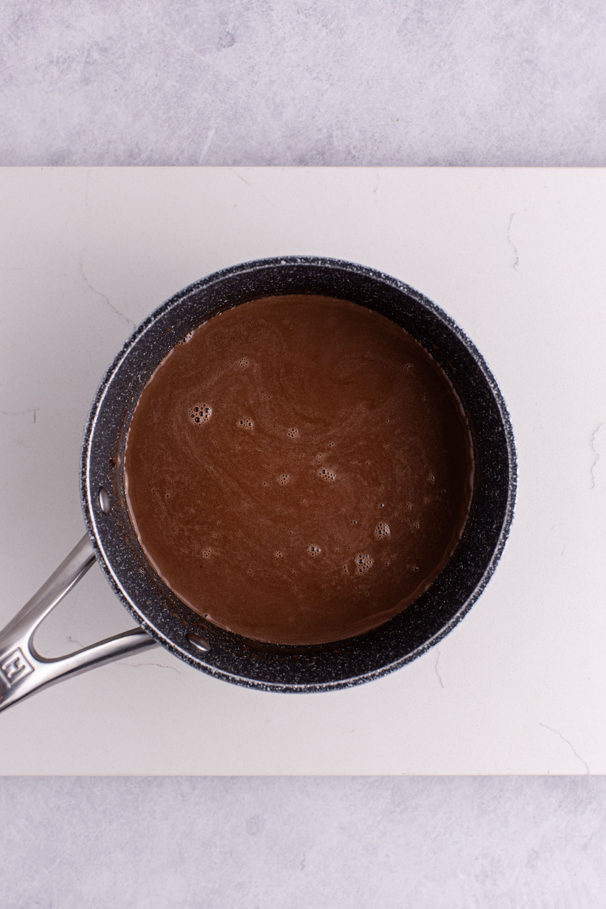 Melted chocolate in a saucepan.