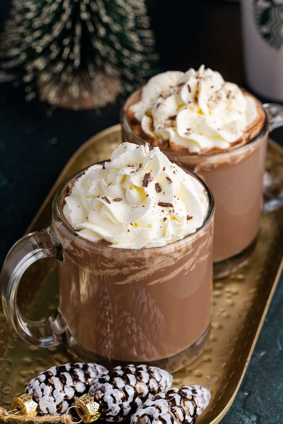 Two cups of hot chocolate on a serving tray.