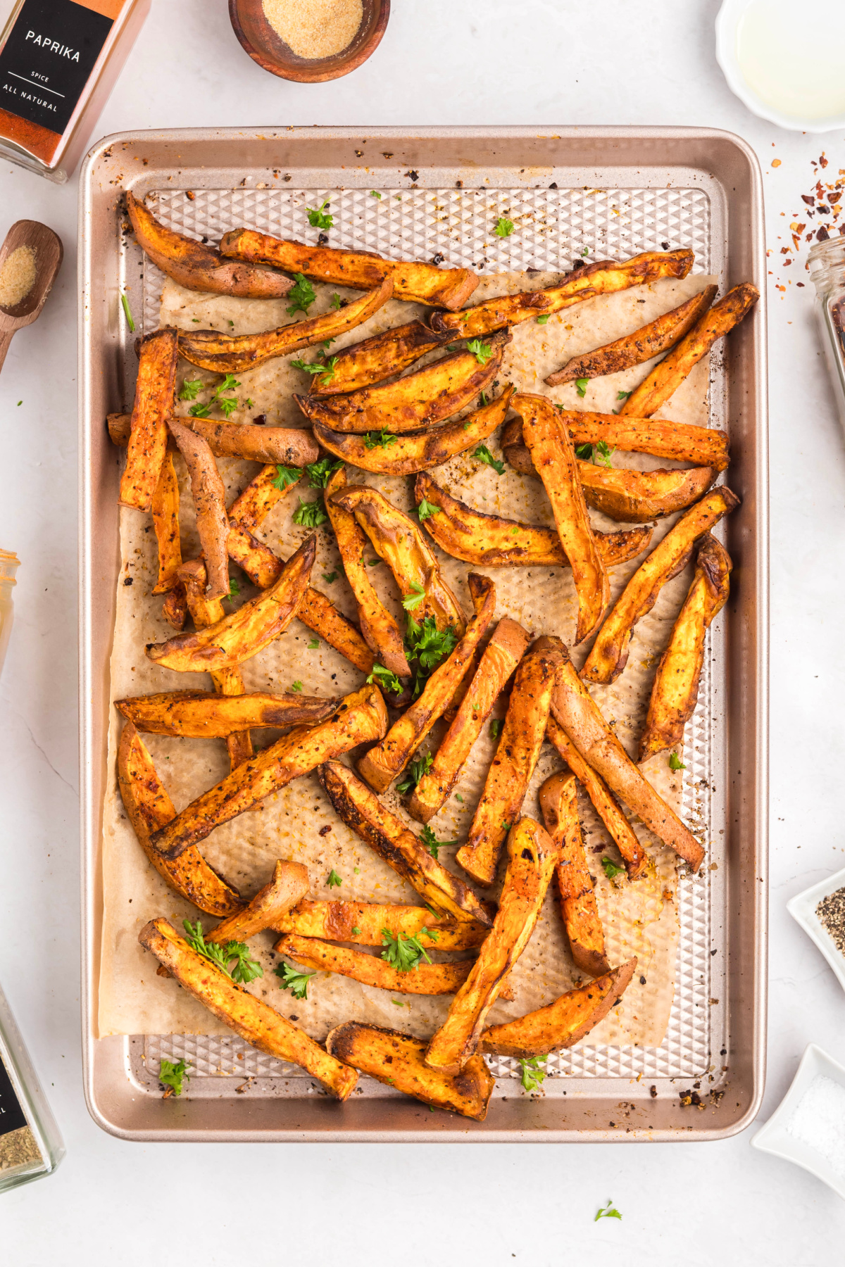 Sweet potatoes cooked and cooling on a sheet pan.