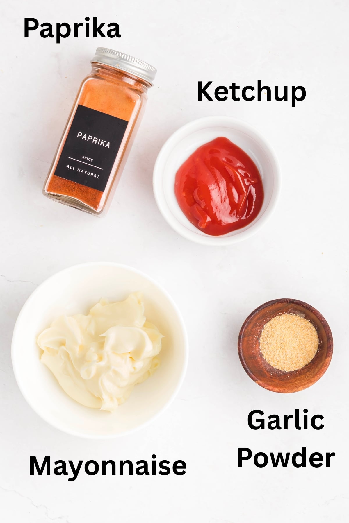 Ingredients to make this dip in bowls on a table.