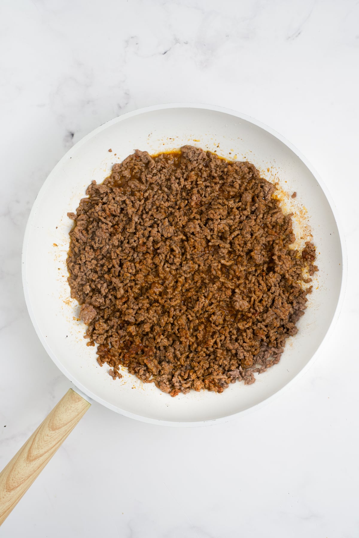 Ground beef cooked in a pan.