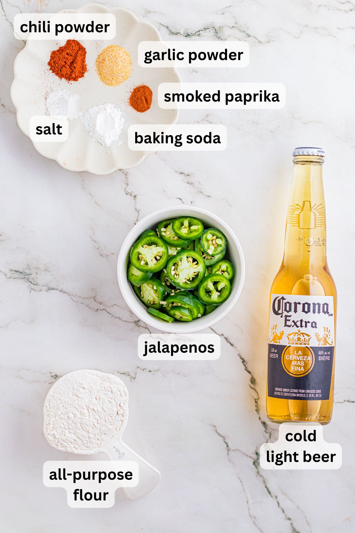 Ingredients to make these fried jalapenos in bowls on a table.
