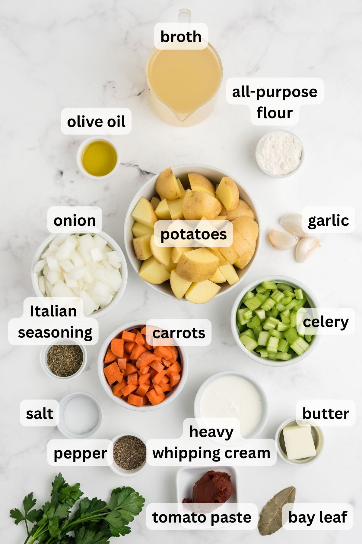 Ingredients to make the potato stew in bowls on a table.