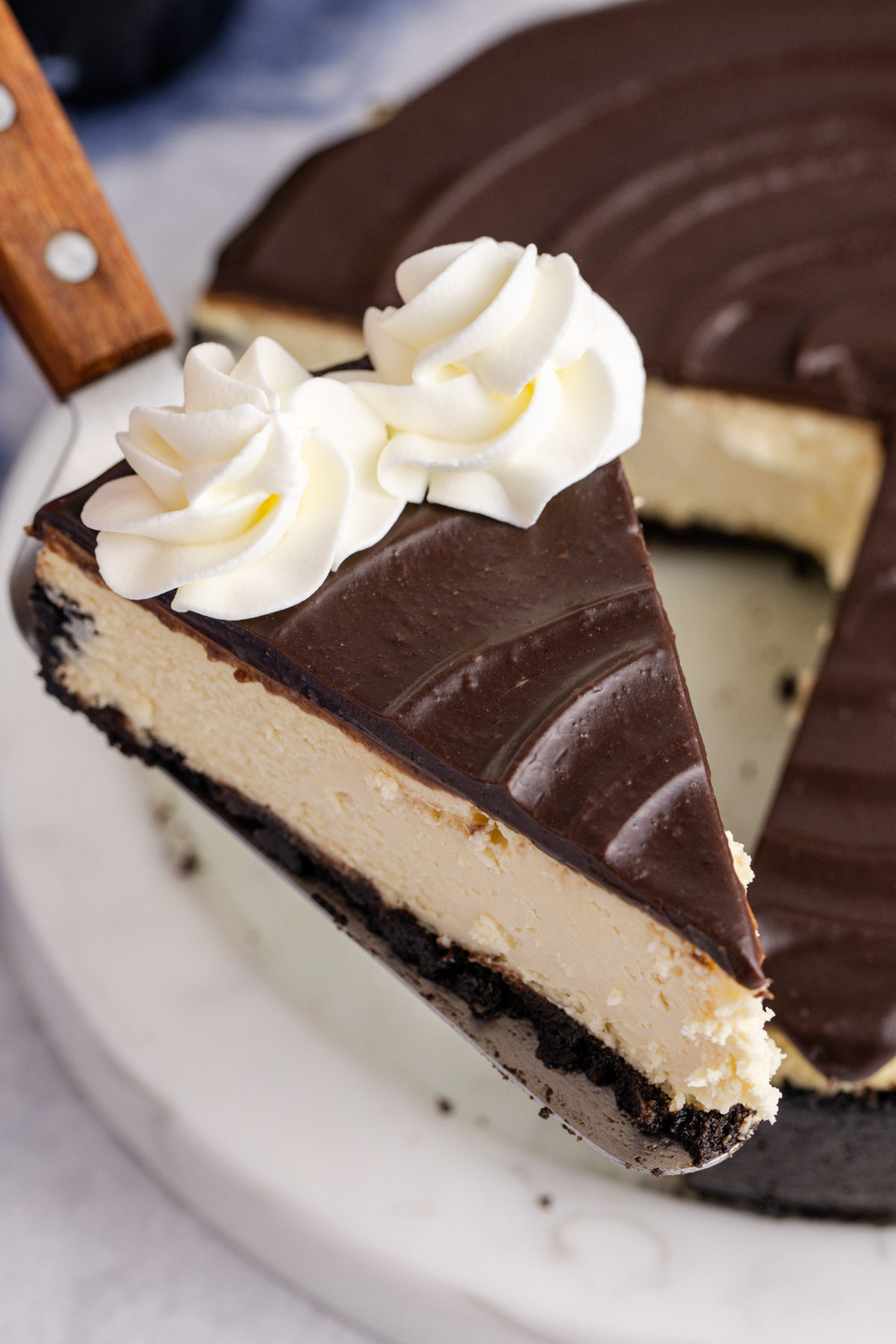 A slice of Bailey's cheesecake lifted up in the air.