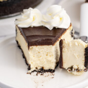 Baileys cheesecake on a plate with a bite taken.