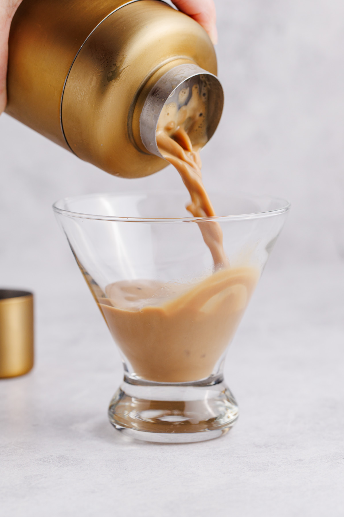 Martini being strained into a glass.