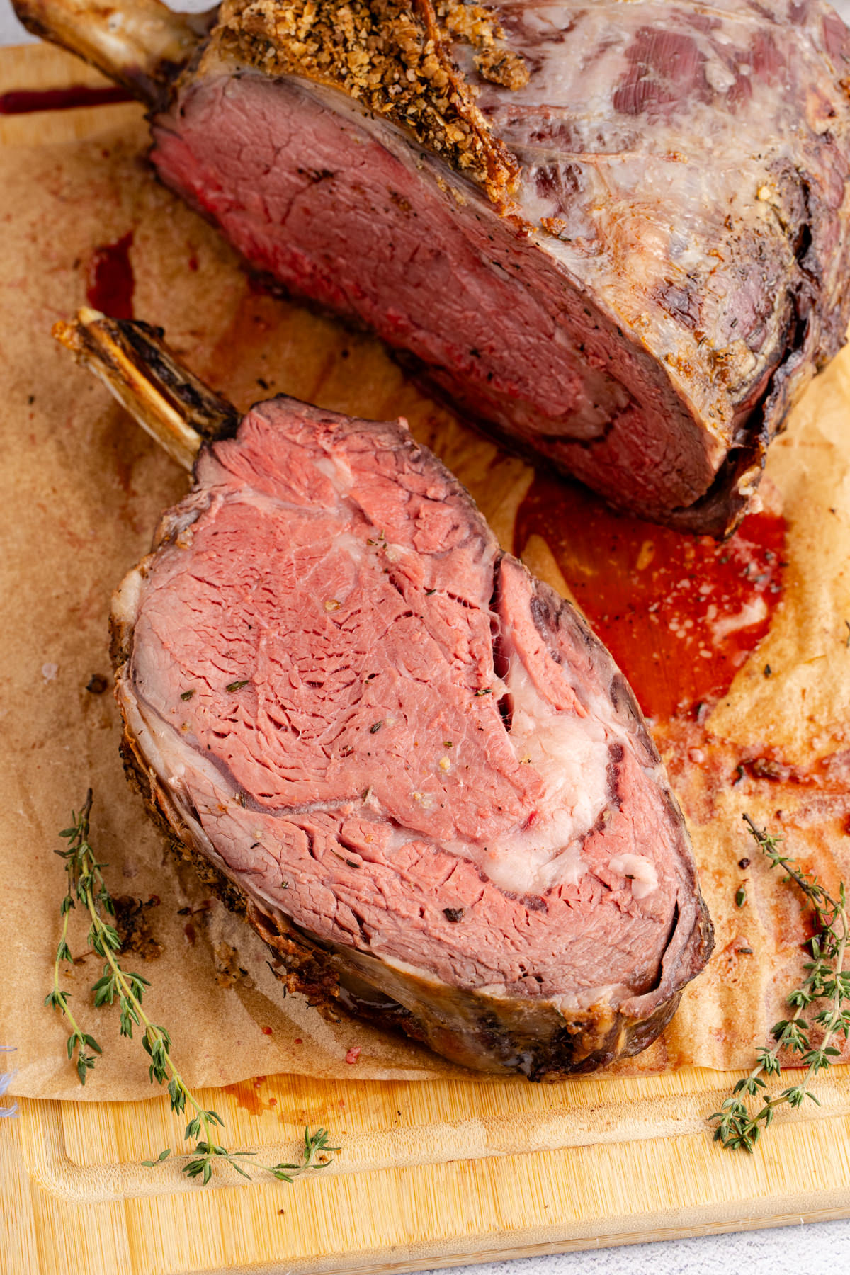 A slice of prime rib on a cutting board.