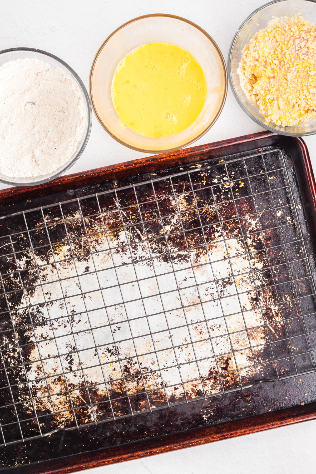 Dredging station set up in bowls with flour, egg, and then breadcrumbs.