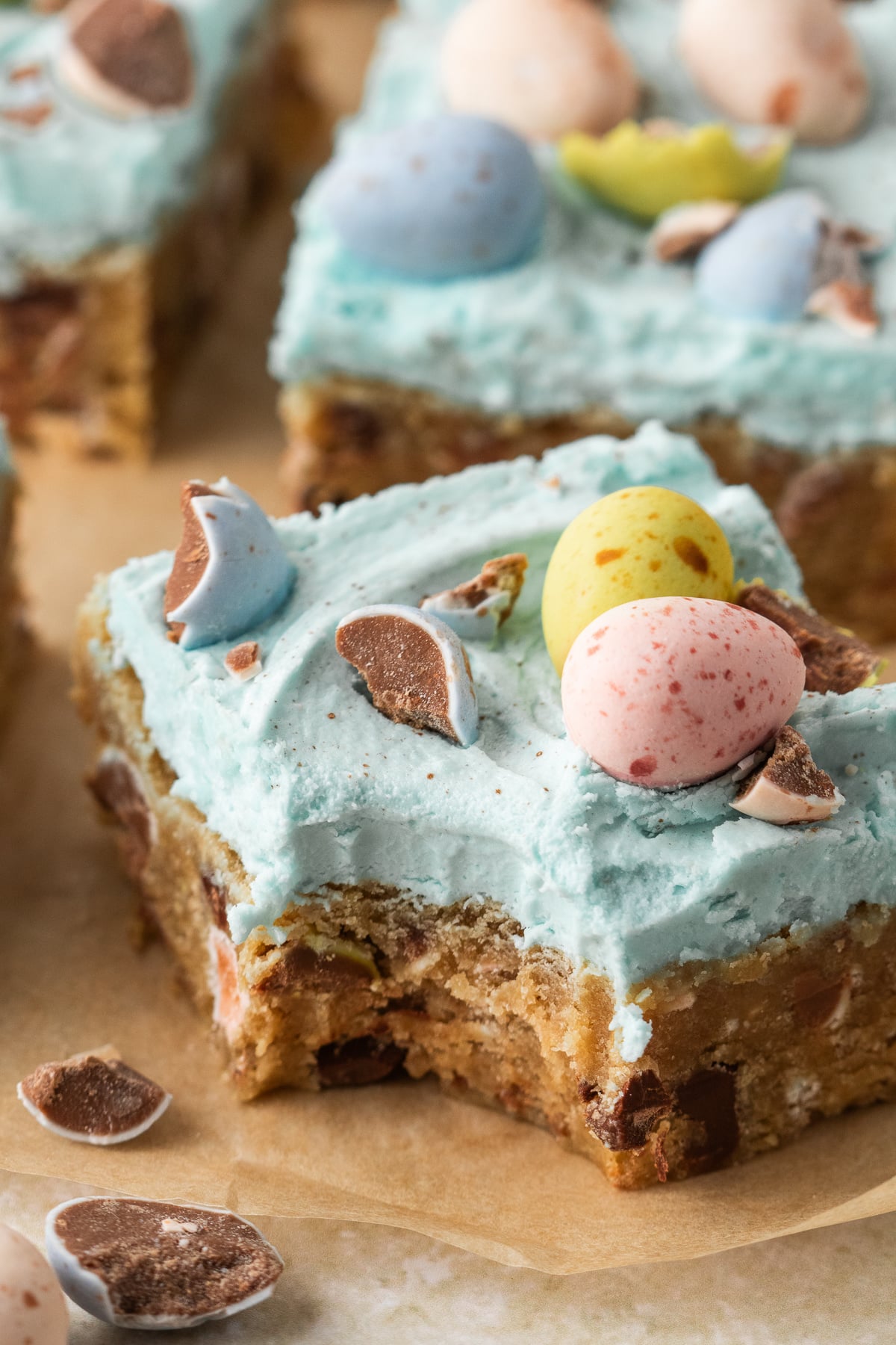 A bite taken out of a cookie bar with Cadbury eggs on top.