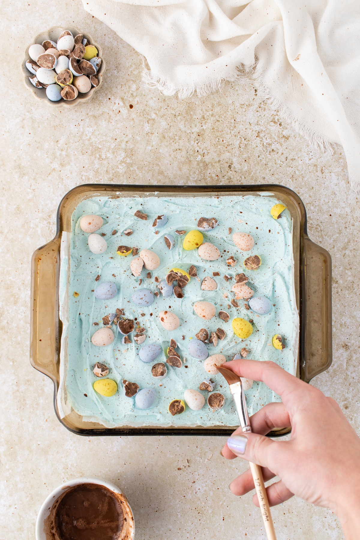 The frosting added to the top of the cookie and chopped Cadbury eggs added over the frosting.