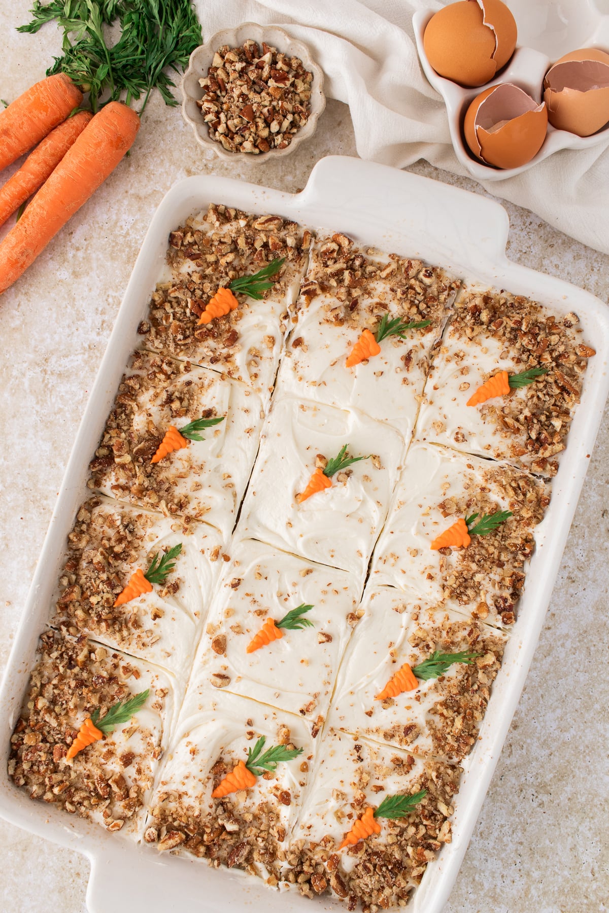 All decoration added to the top of the carrot cake sheet cake.