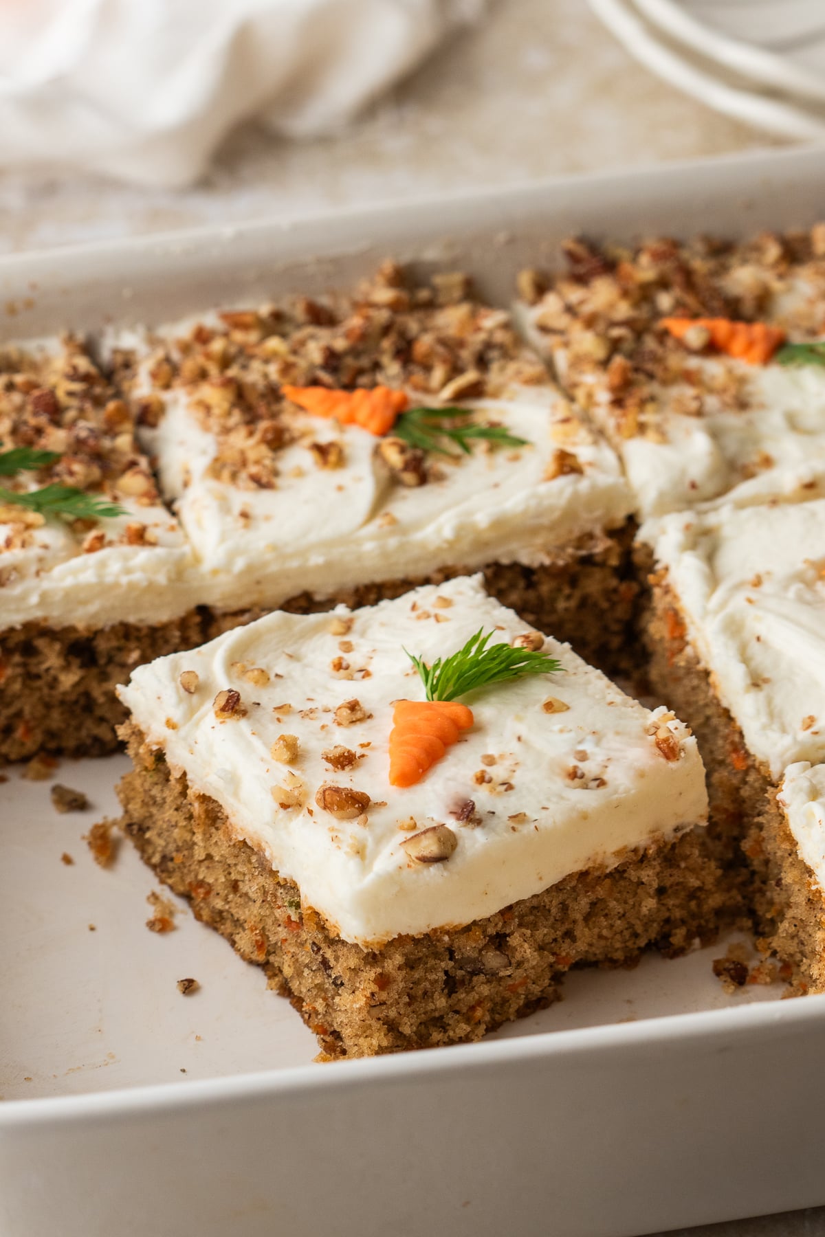 A slice of carrot cake cut from the baking dish.