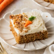 A slice of carrot cake sheet cake on a plate.