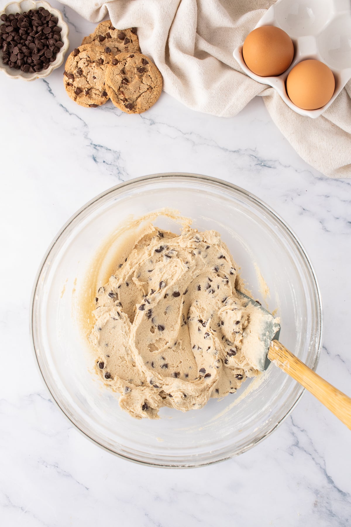 The butter, sugar and wet ingredients in a bowl to make the chocolate chip cookie dough.